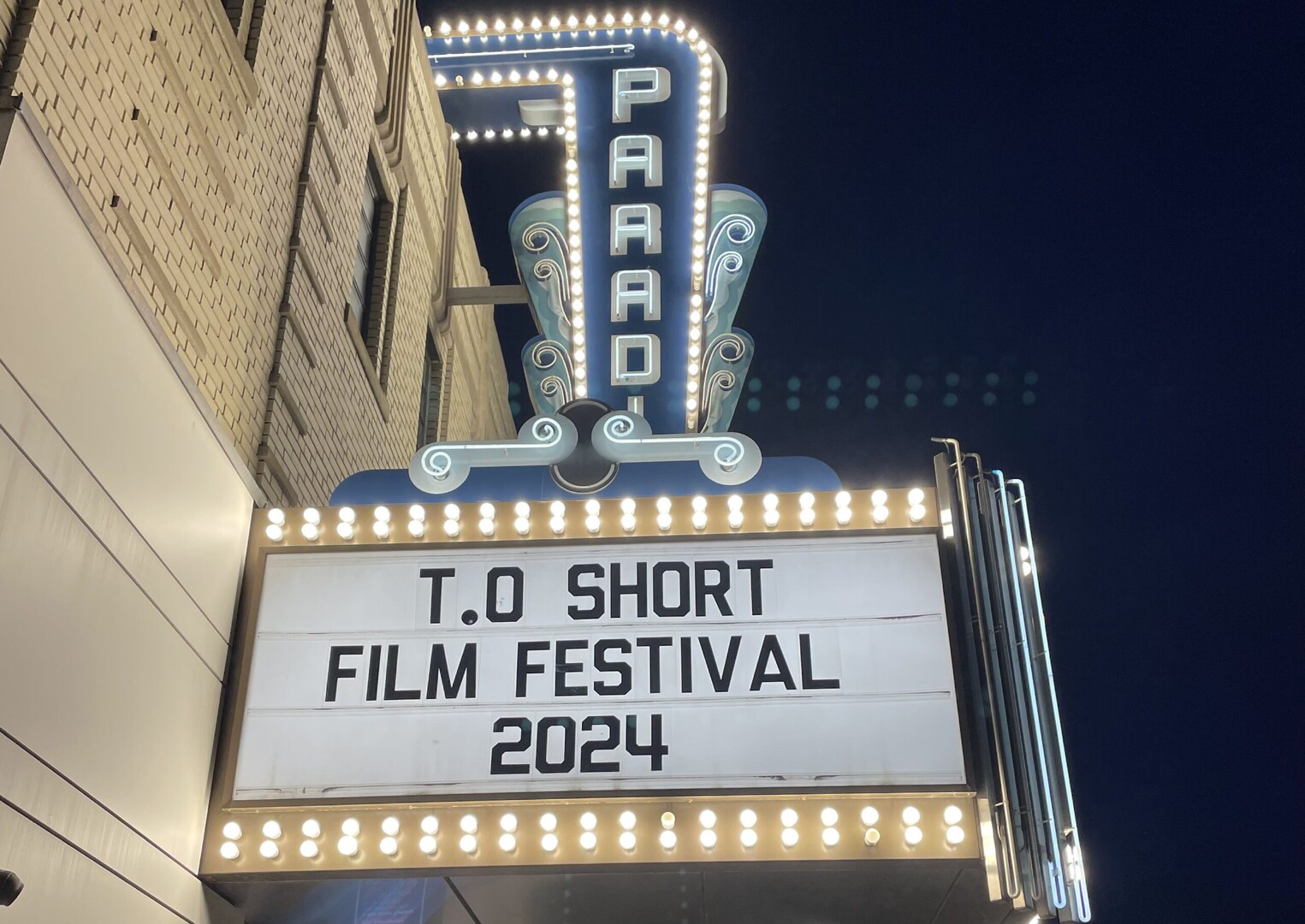 The Paradise Cinema marquee and neon blade sign glowing at night for the Toronto Short Film Festival